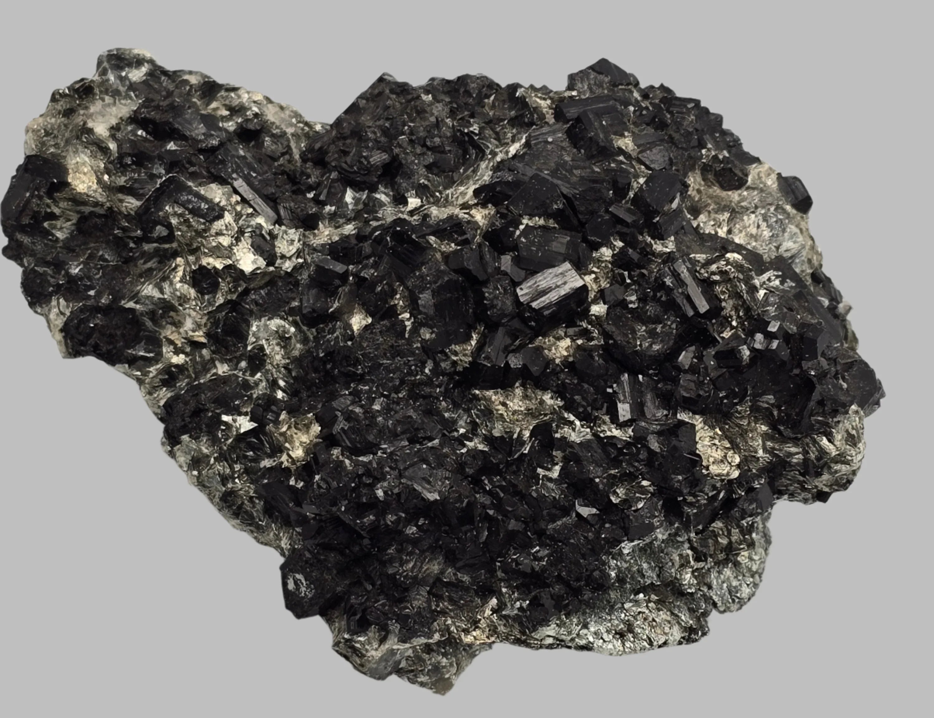 Black tourmaline crystal specimen with metallic matrix, mineral collector's display piece