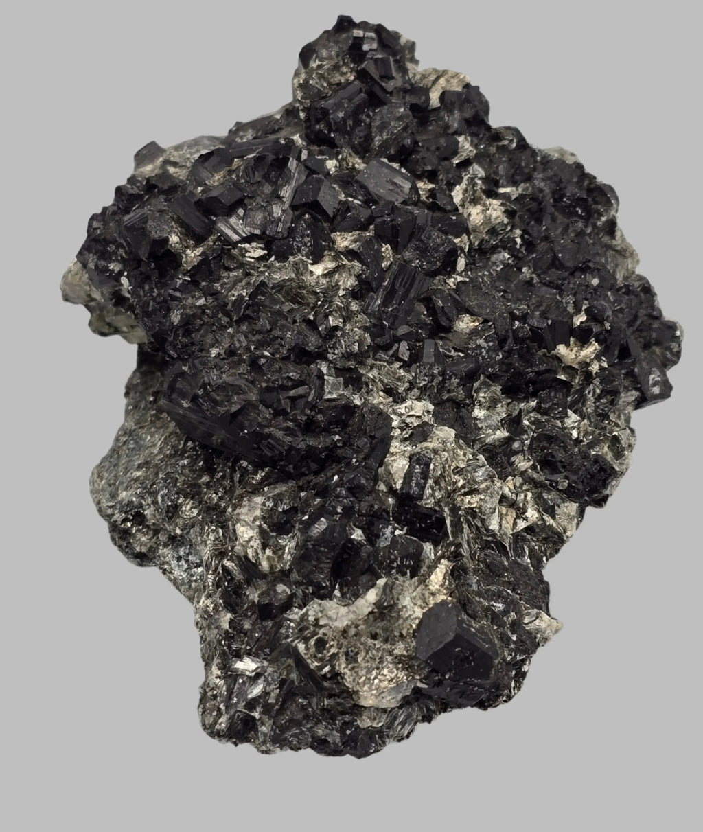 Hematite mineral specimen with metallic luster and crystalline structure on matrix