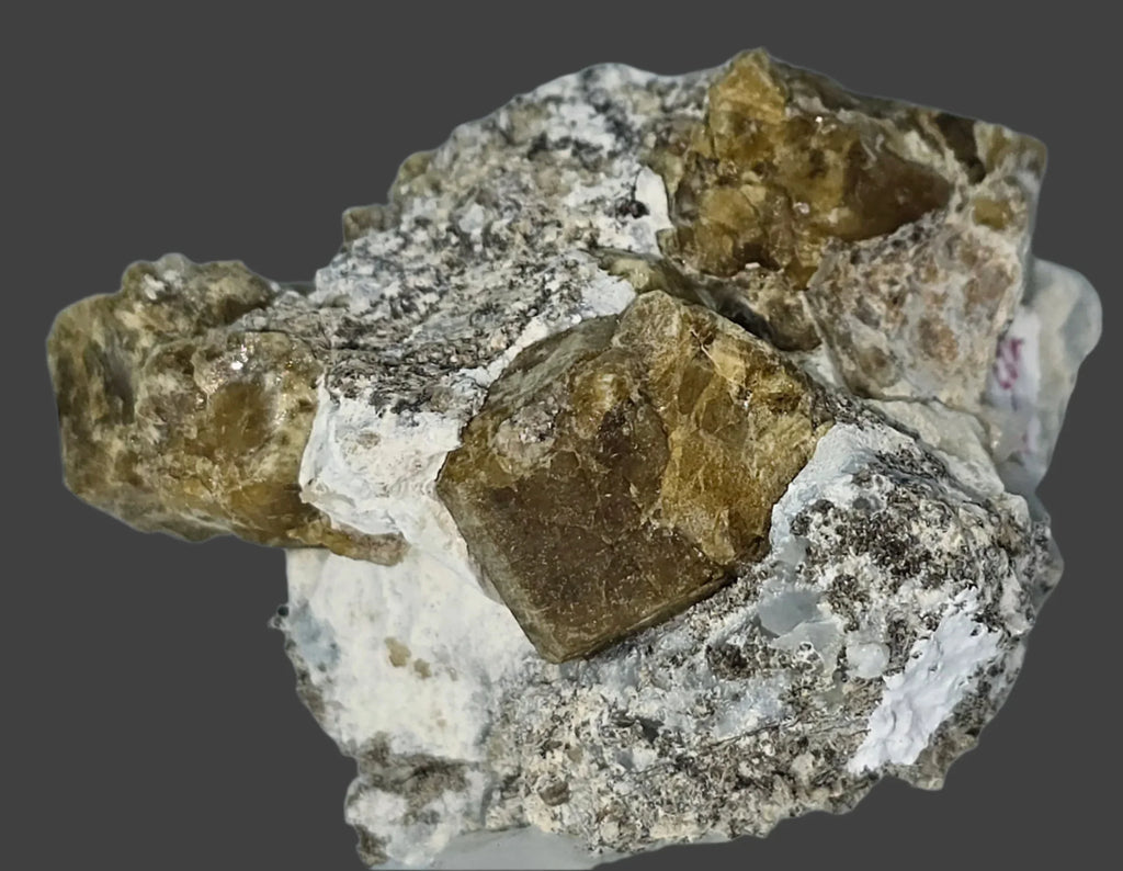 Fluorite crystal specimen with cubic formation on matrix, showcasing earthy tones and natural mineral texture