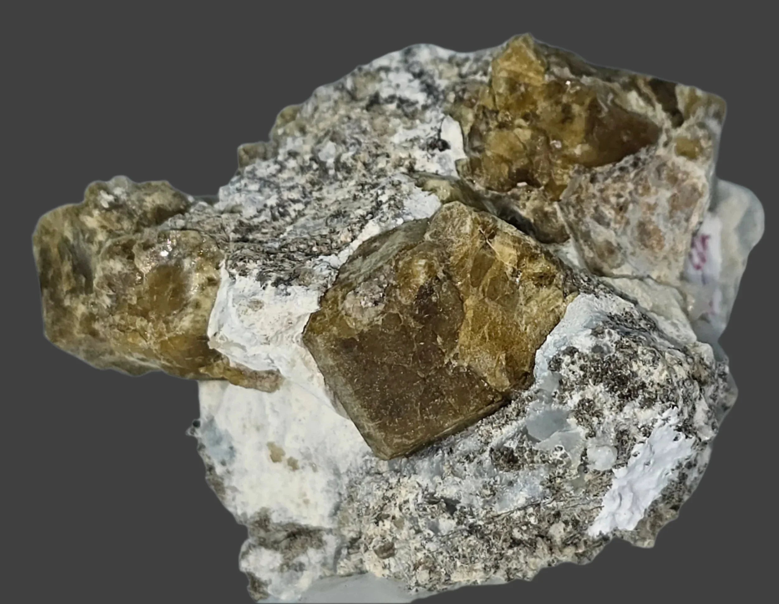 Fluorite crystal specimen with cubic formation on matrix, showcasing earthy tones and natural mineral texture