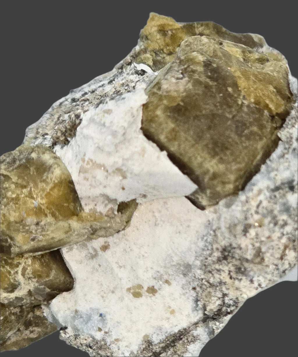 Fluorite crystal specimen with white matrix, showcasing natural mineral formation and earthy tones