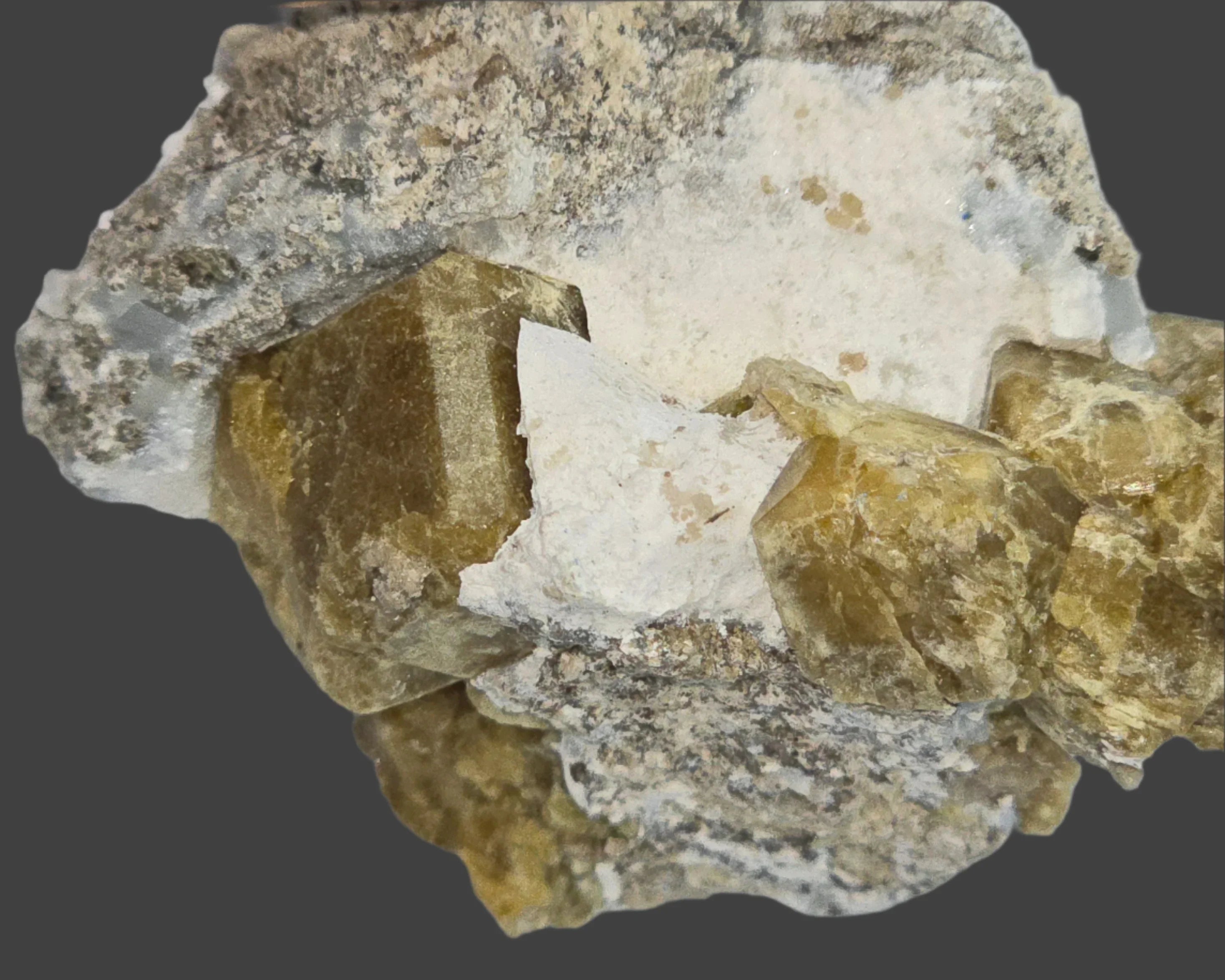 Fluorite crystals on matrix, showcasing natural mineral specimen with earthy tones and geometric formations