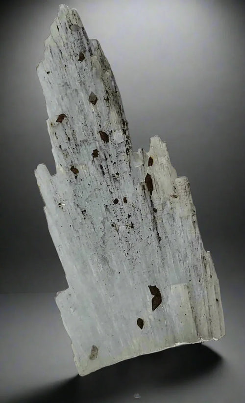 White calcite crystal with brown inclusions, mineral specimen for collectors