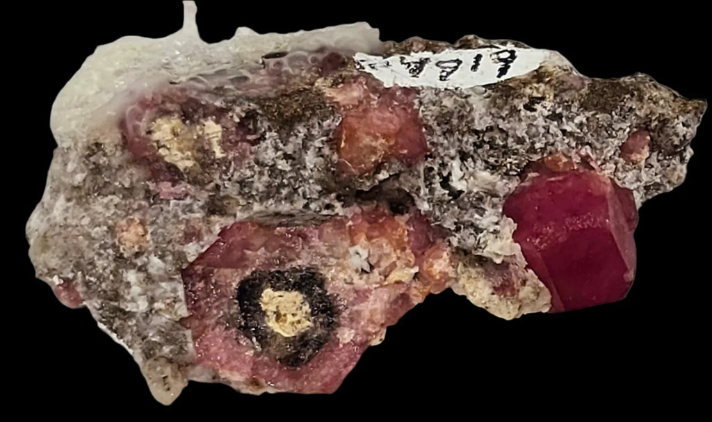 Ruby crystal in matrix from Mogok, Myanmar, showcasing deep red gemstone with geological inclusions