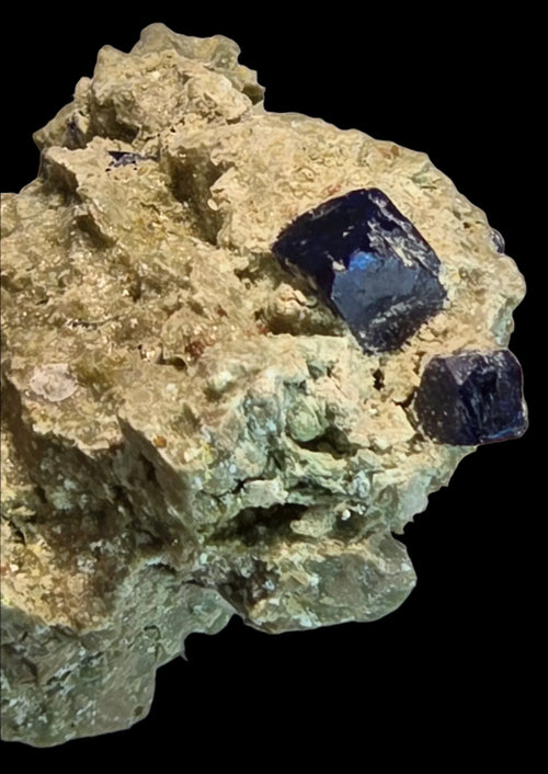 Cubic fluorite crystals on matrix, showcasing deep blue gemmy specimens for mineral collectors
