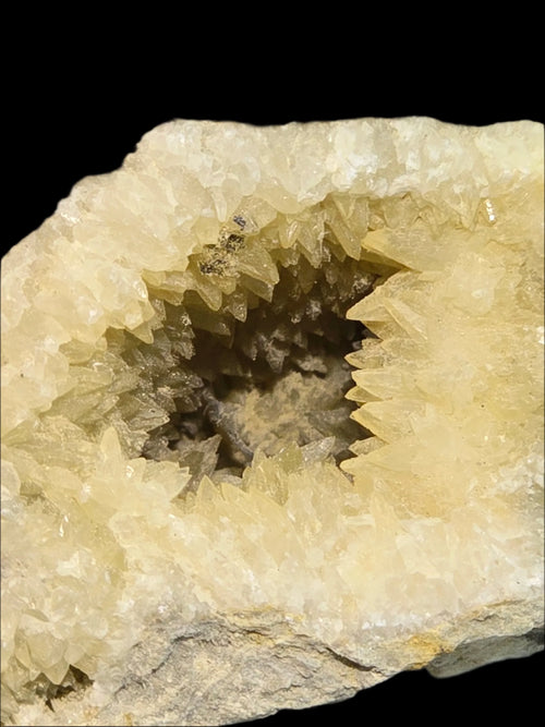 Calcite crystal cluster from Morocco, showcasing sharp, golden-yellow terminations and natural geode formation.