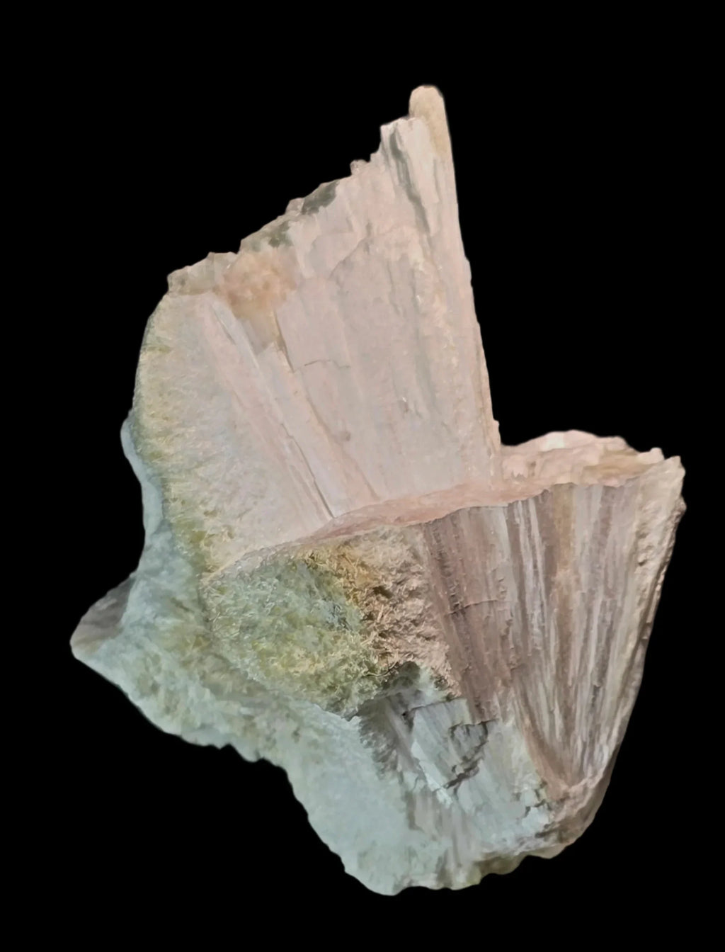 Stilbite mineral specimen with pink and green hues, natural crystal formation on dark background
