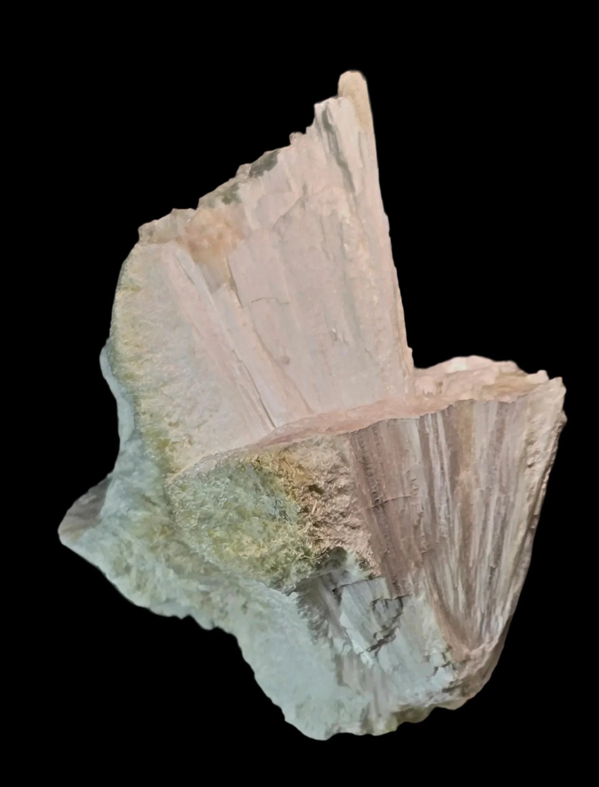 Stilbite mineral specimen with pink and green hues, natural crystal formation on dark background