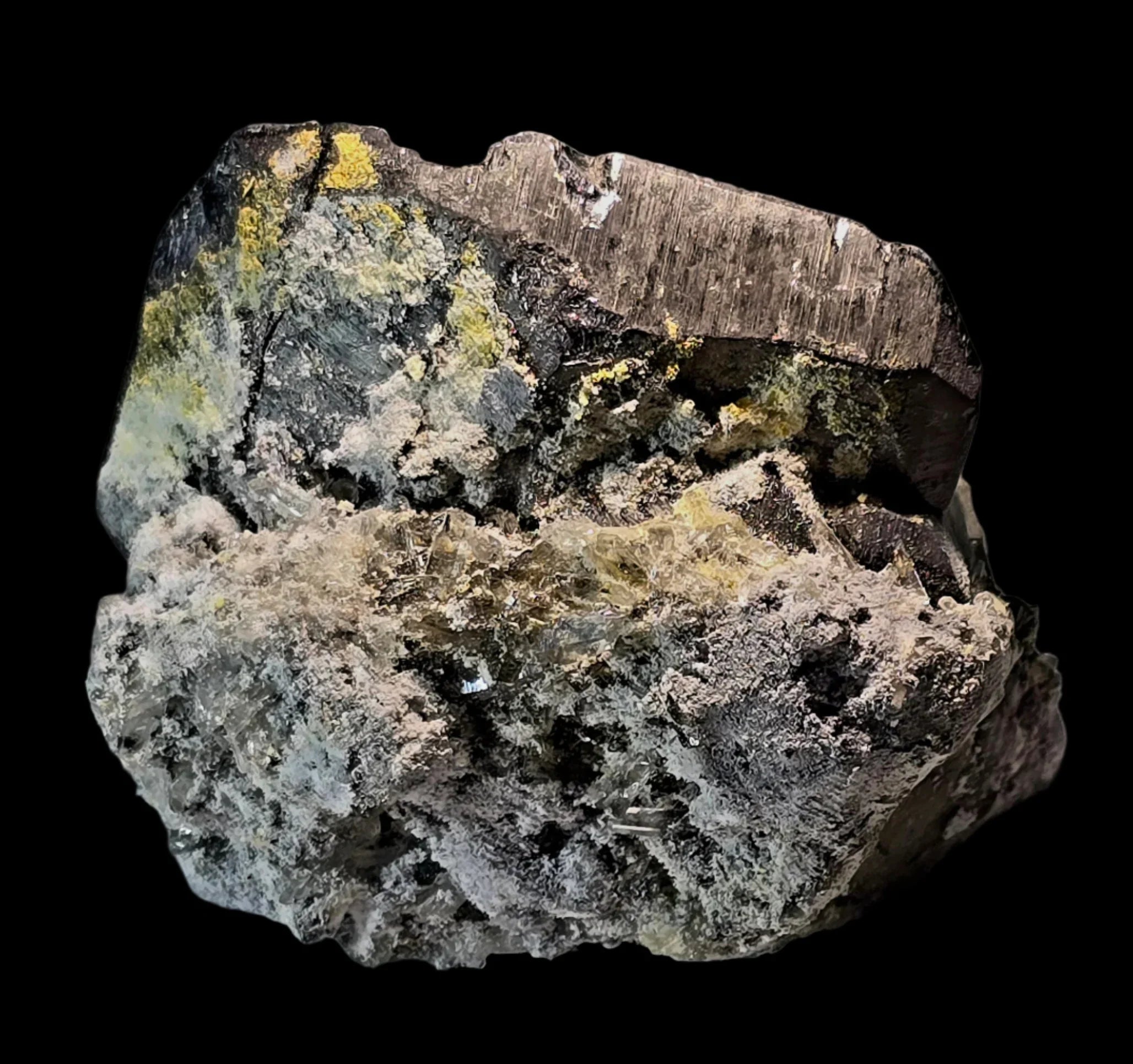 Sphalerite with yellow and gray mineral inclusions on dark matrix, classic locality specimen