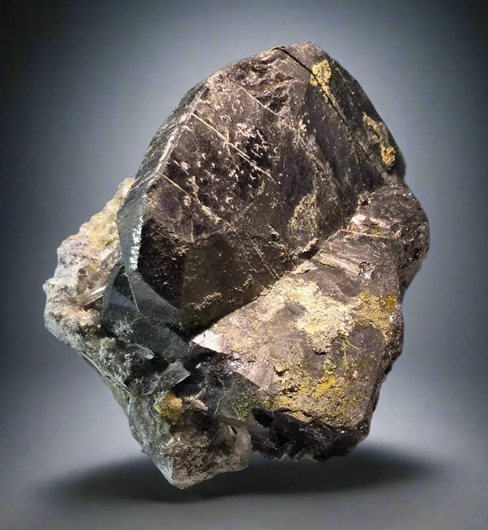 Hematite crystal specimen with metallic luster and golden inclusions, mineral collector's piece
