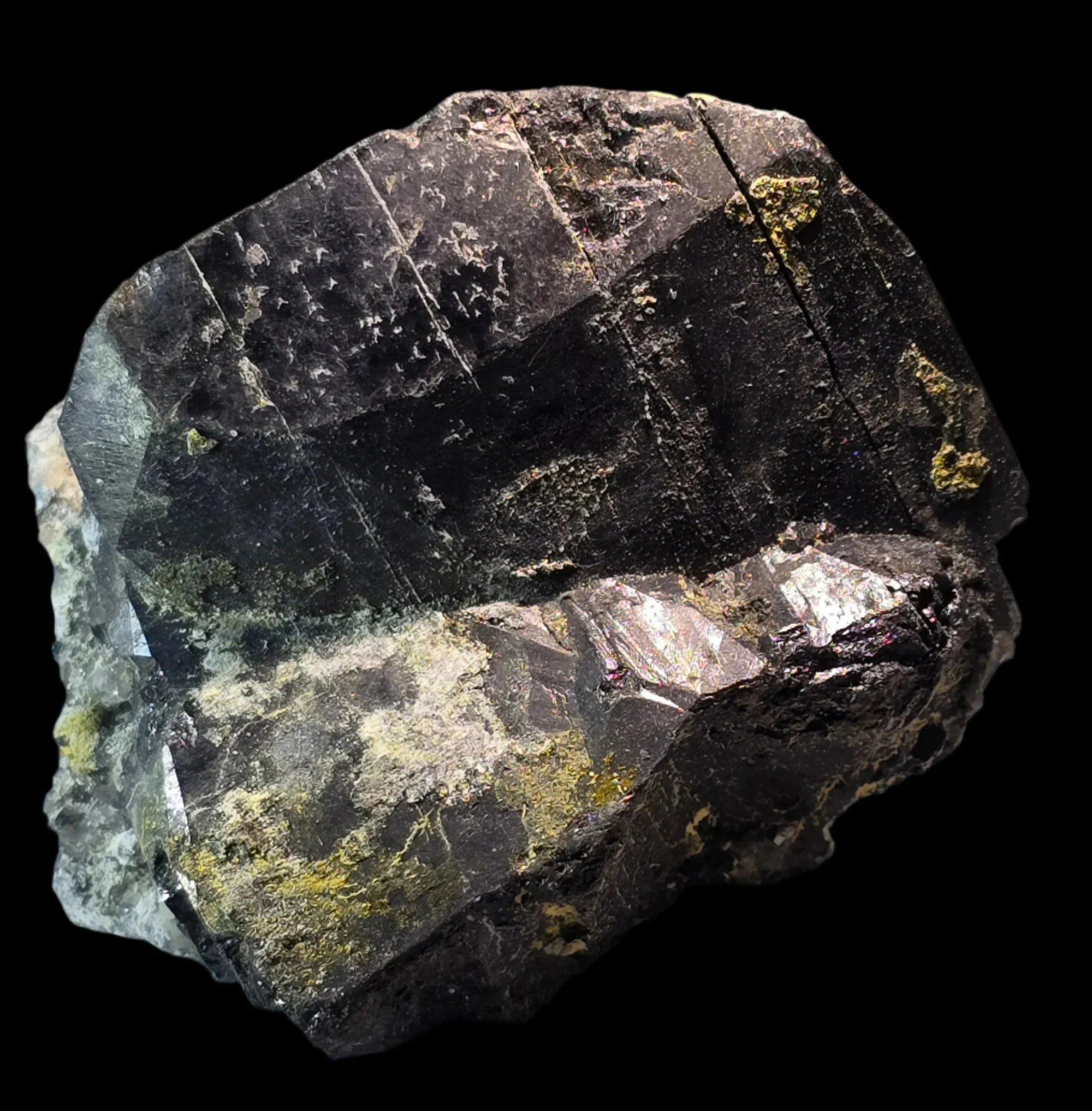 Fluorite crystal with green and yellow inclusions, showcasing natural mineral formation and geometric cleavage planes.