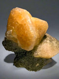 Calcite crystal specimen from Elmwood Mine, Tennessee, showcasing vibrant orange-yellow hues and natural mineral formation.