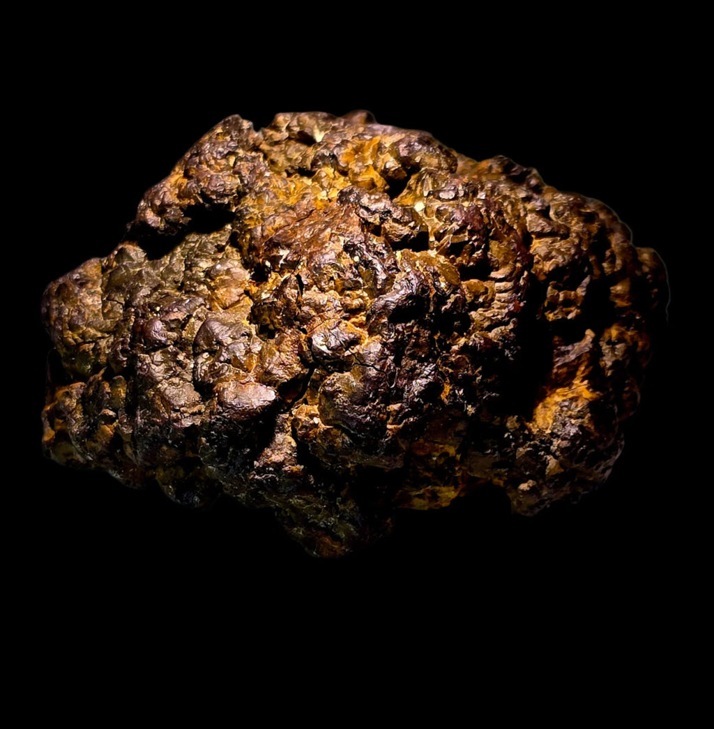 Pyrite mineral specimen with golden-brown metallic luster, rough textured crystal formation on black background