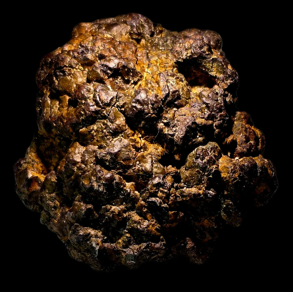 Pyrite mineral specimen with golden-brown metallic luster, rough textured crystal cluster against black background