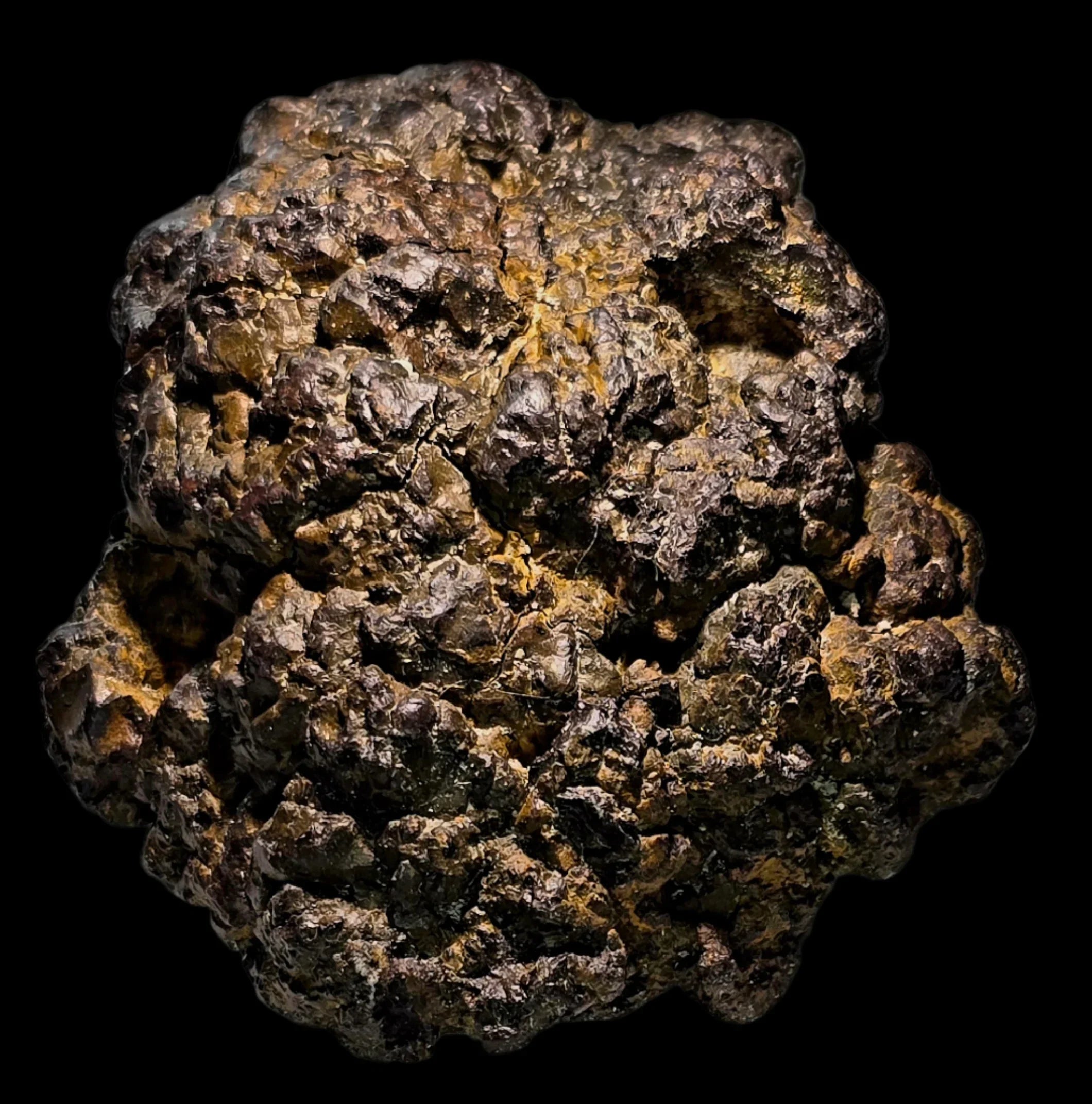 Pyrite mineral specimen with rugged, metallic gold-brown texture against black background