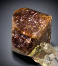 Fluorite cube with purple and golden hues, showcasing natural mineral crystal formation