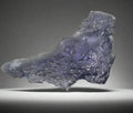 Fluorite crystal specimen with purple-blue hues, rough natural formation, mineral collector display