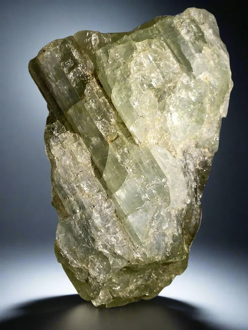 Prehnite crystal specimen from South Africa, showcasing translucent green prismatic formations on matrix
