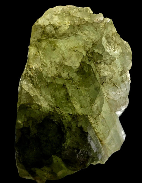 Green fluorite crystal specimen with natural matrix, showcasing translucent layers and earthy tones