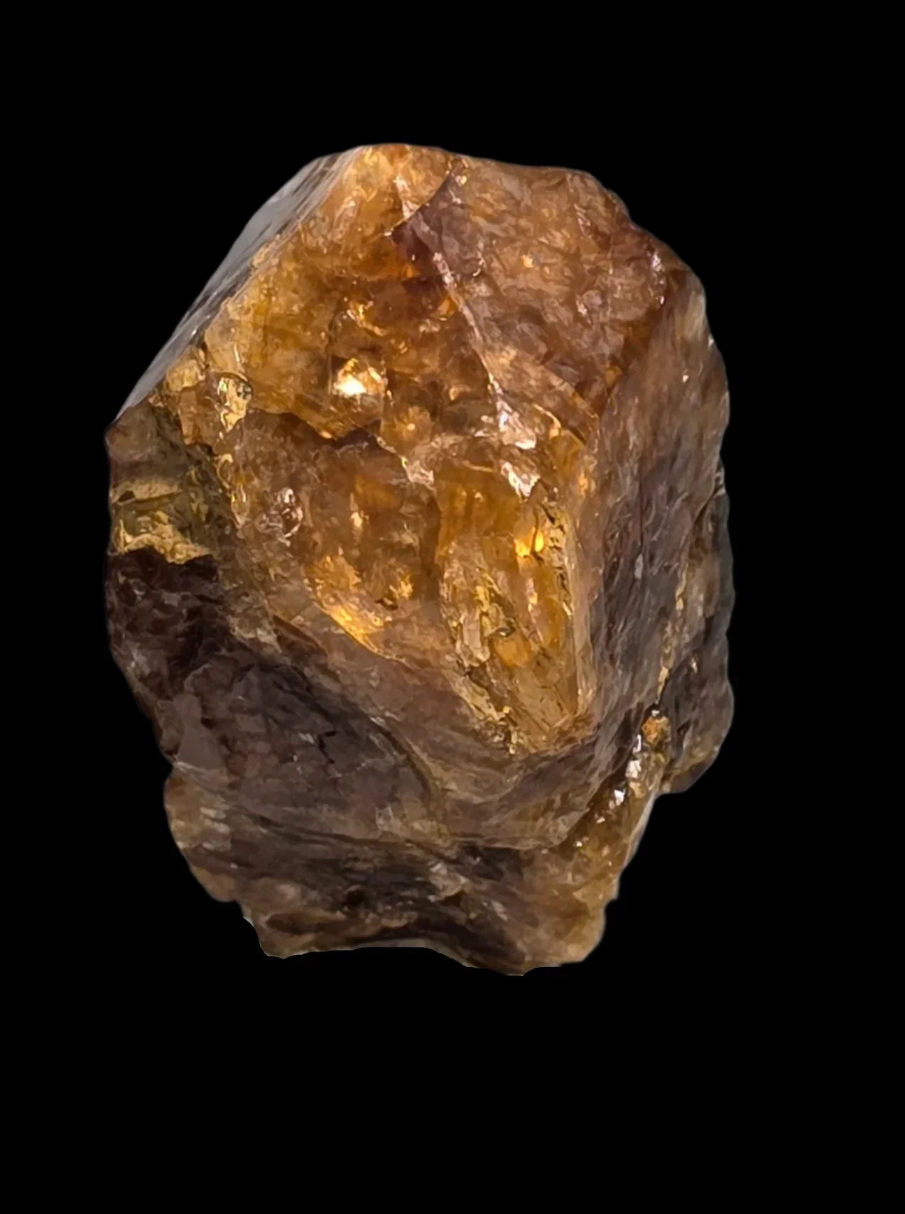 Citrine crystal specimen with golden amber hues, natural mineral formation against black background