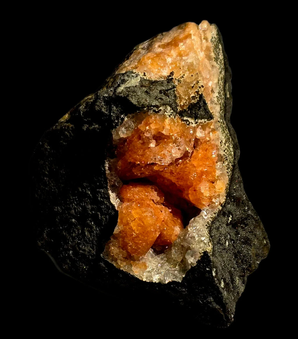 Orange calcite crystal specimen from classic locality, vibrant mineral formation on dark matrix