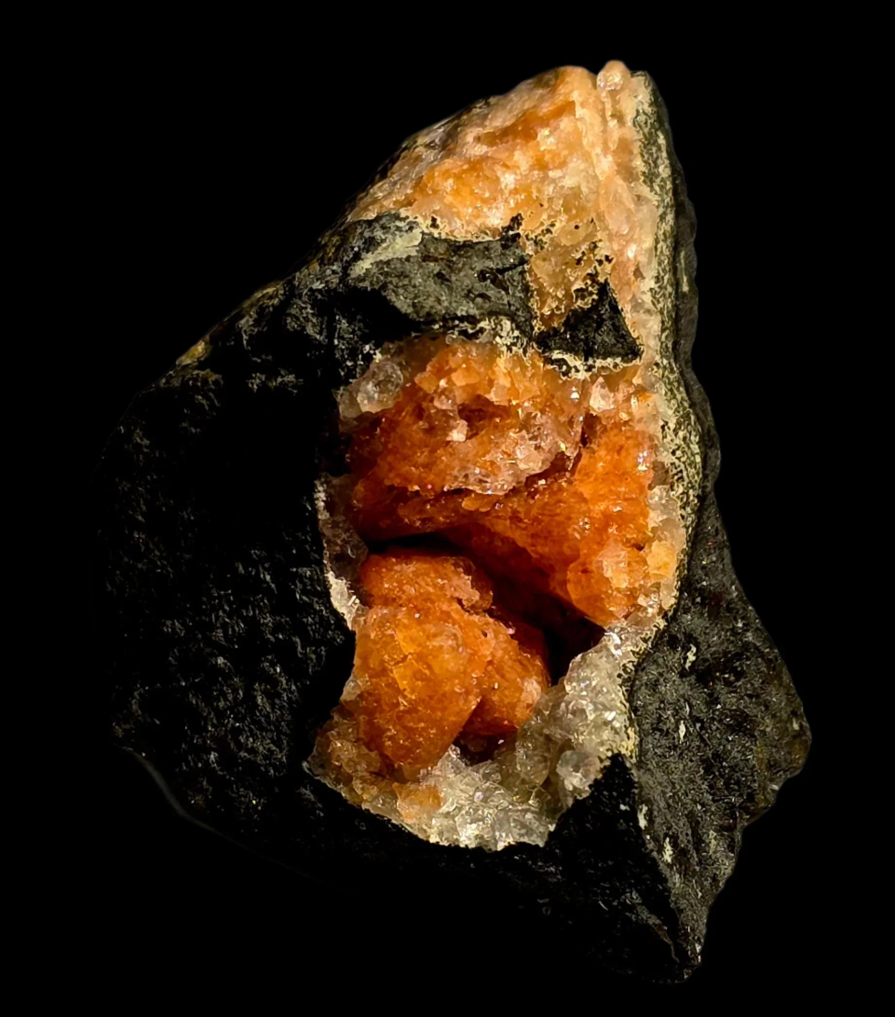 Orange calcite crystal specimen from classic locality, vibrant mineral formation on dark matrix
