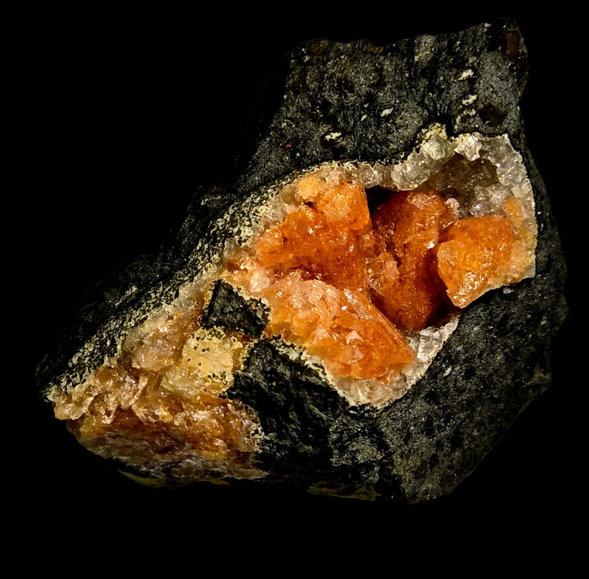 Orange crystals in dark matrix, mineral specimen for collectors