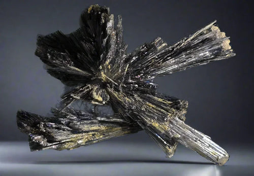 Stibnite mineral specimen from China, featuring striking metallic luster and radiating crystal clusters