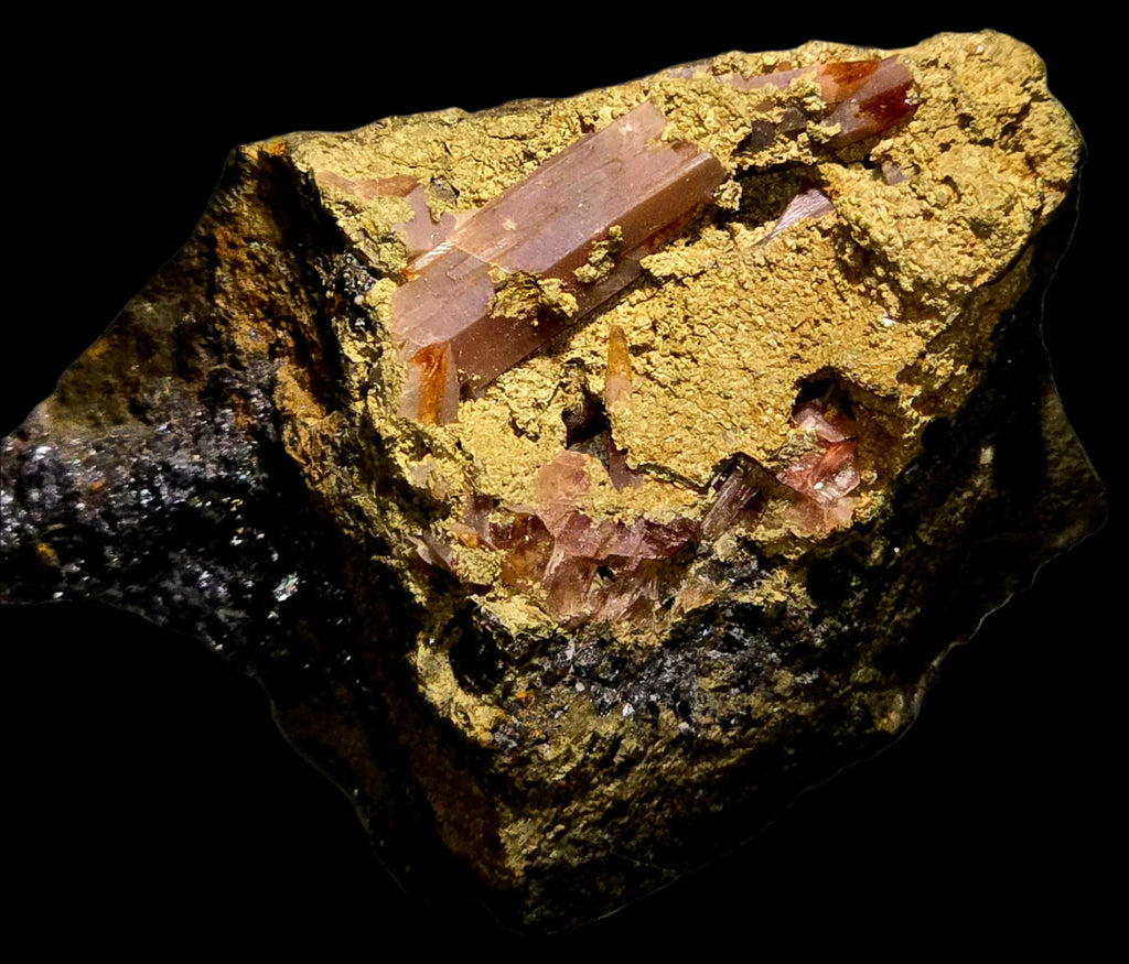 Aragonite crystals on matrix from Spain, showcasing translucent reddish-brown prisms against yellow earthy coating.