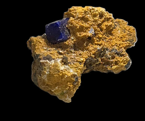 Sodalite on matrix from Mont Saint-Hilaire, Canada - vibrant blue crystal on yellow-orange host rock