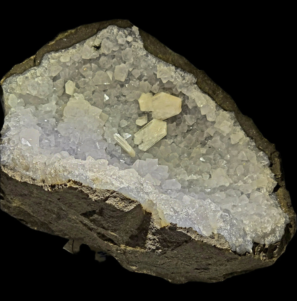Celestine crystal cluster with matrix, showcasing clear to pale yellow cubic crystals on dark rock base