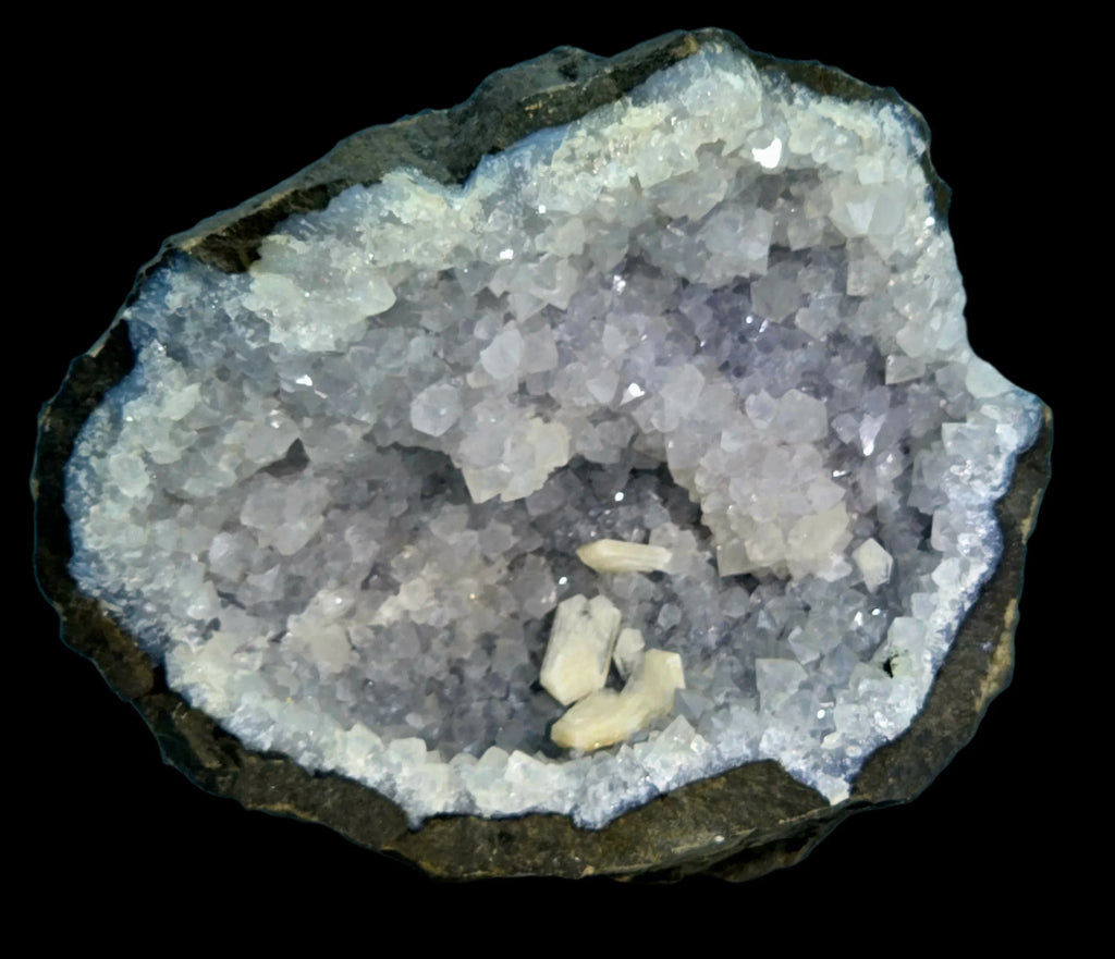 Celestine crystal cluster from Madagascar, showcasing white to pale blue cubic crystals in a geode matrix