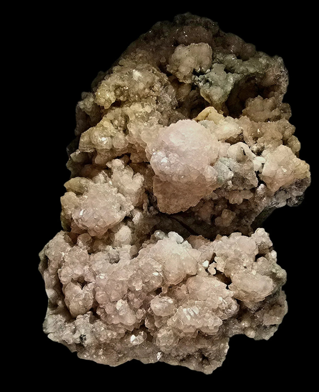 Heulandite mineral specimen from India, featuring clustered pale pink and white crystals on dark matrix