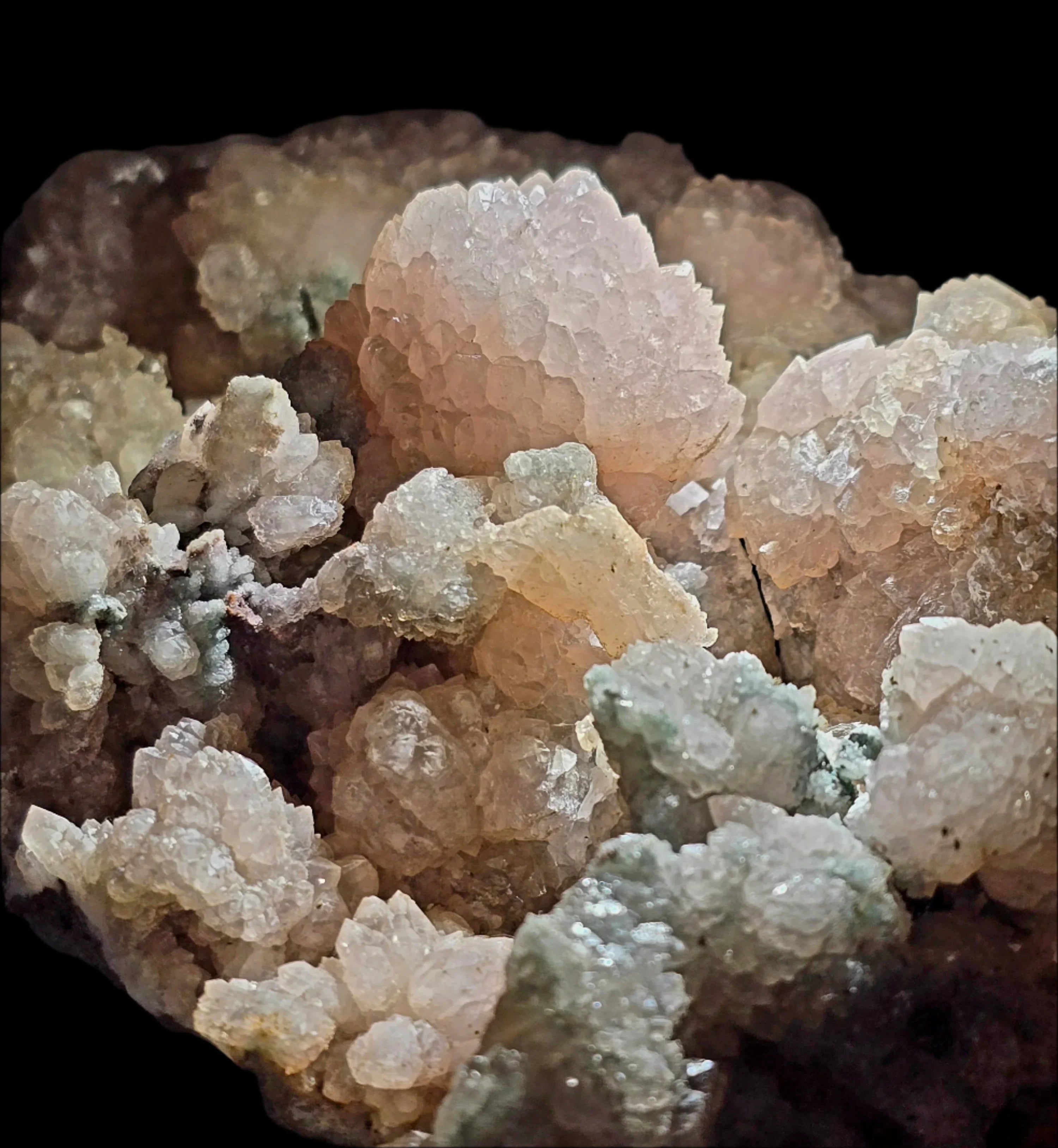 Heulandite crystal cluster with delicate pink and white formations on matrix
