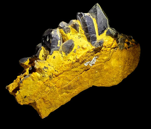 Cassiterite crystals on vibrant yellow matrix, classic mineral specimen for collectors