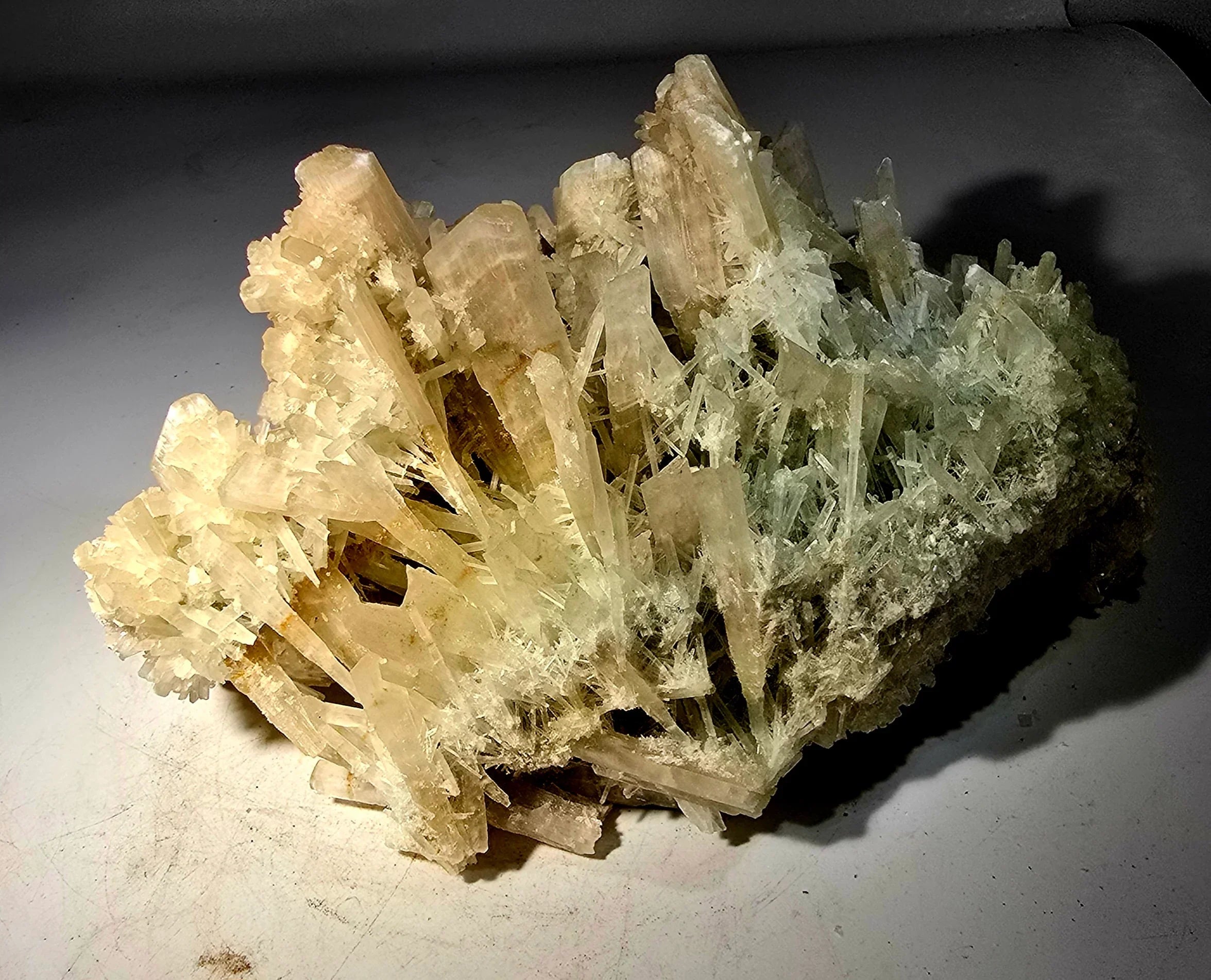 Celestine crystal cluster from Madagascar, featuring translucent pale blue and white prismatic formations on matrix.