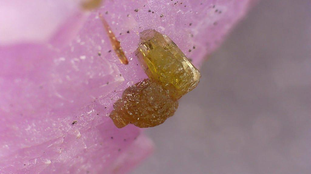 Yellow crystal specimen on pink matrix, mineral collector's display