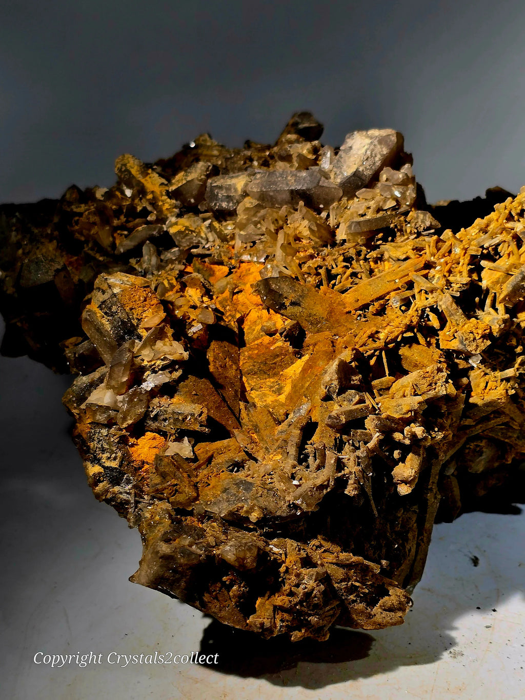Calcite crystals on matrix with orange mineral coating, specimen from classic locality