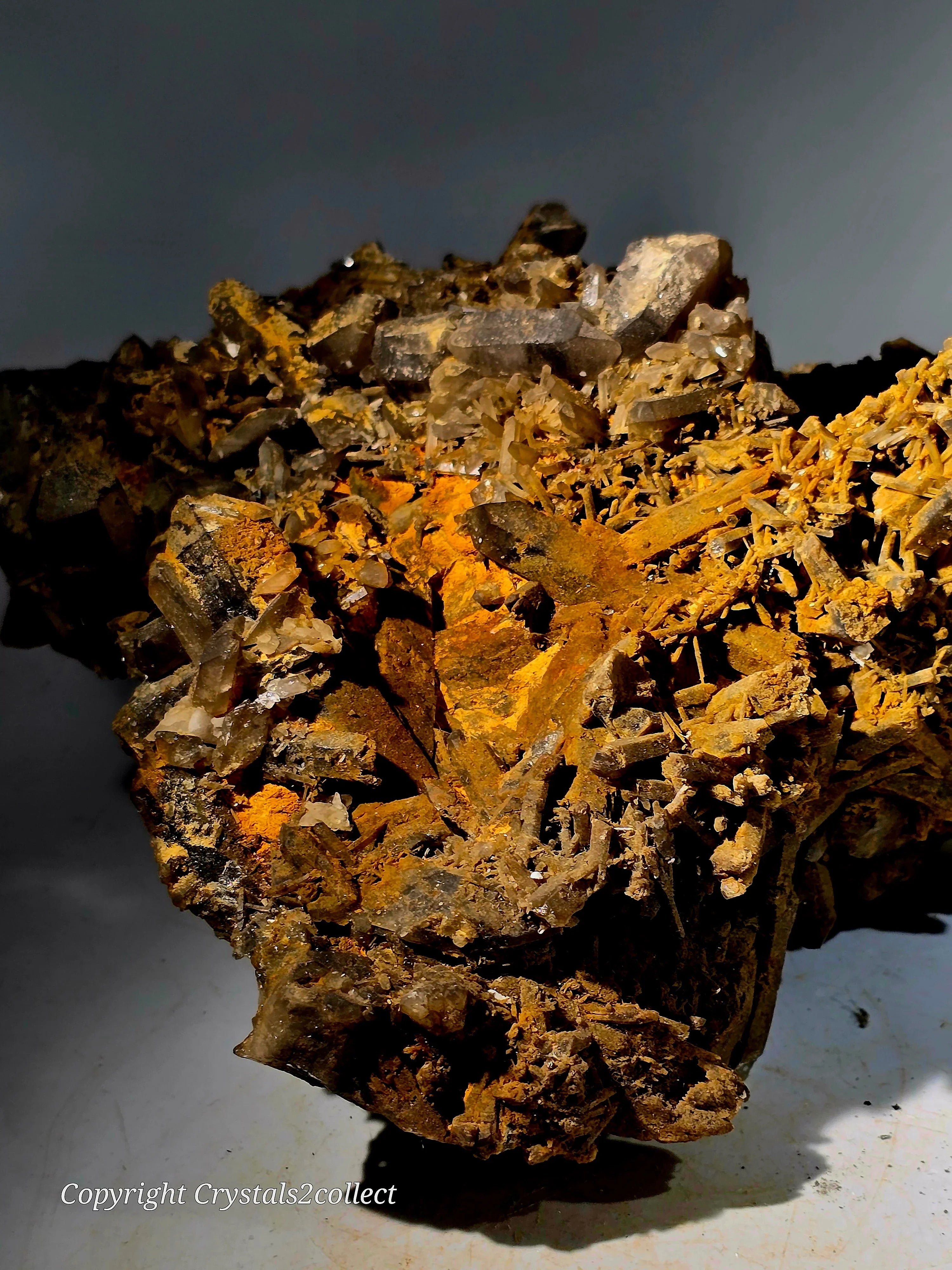 Calcite crystals on matrix with orange mineral coating, specimen from classic locality