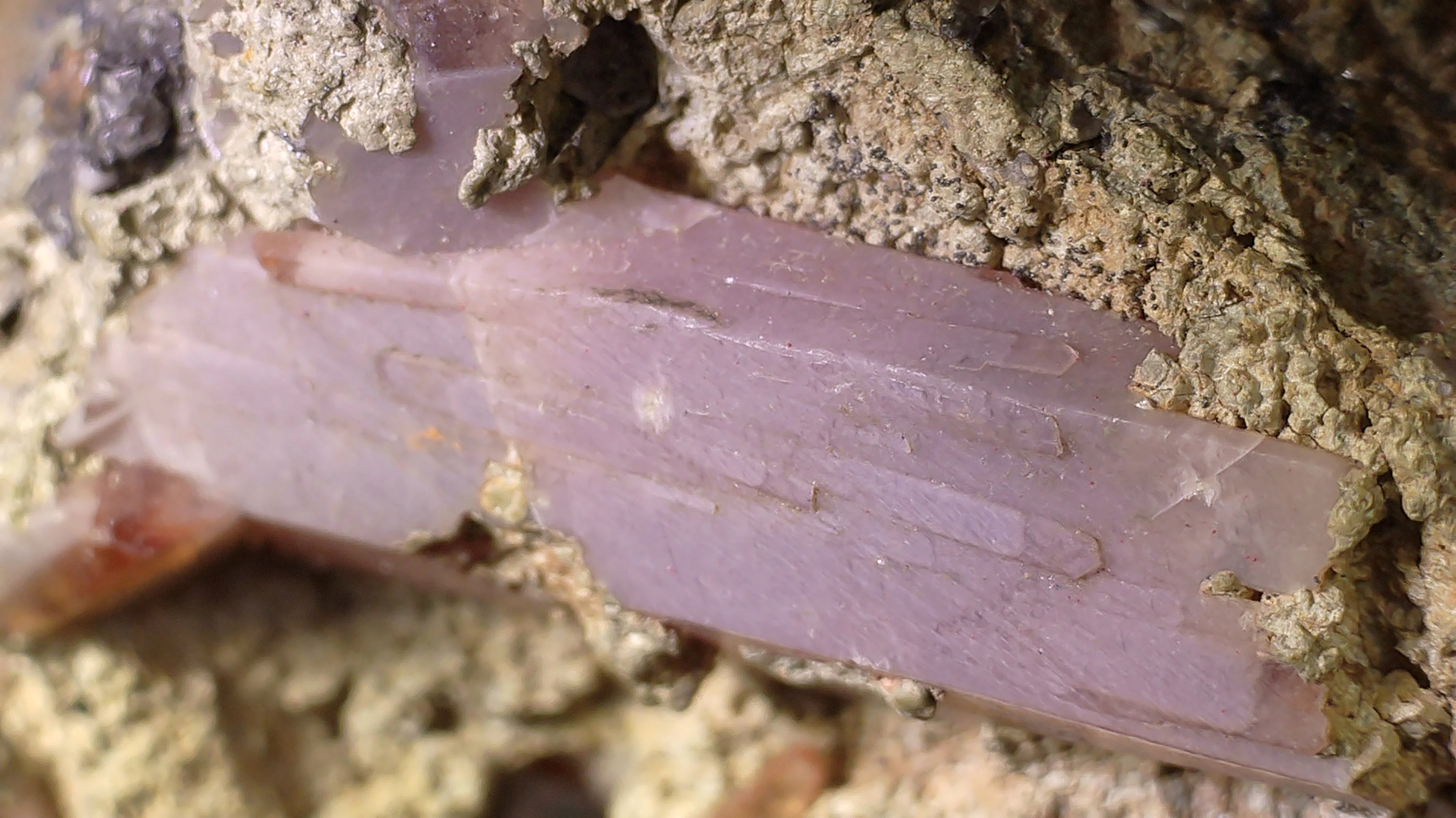 Pink Kunzite crystal in matrix, showcasing natural mineral formation and geological texture