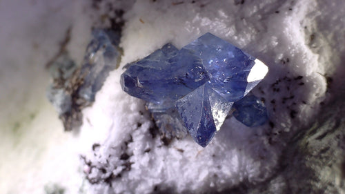 Blue sapphire crystal specimen with sharp facets on white matrix, mineral collector specimen