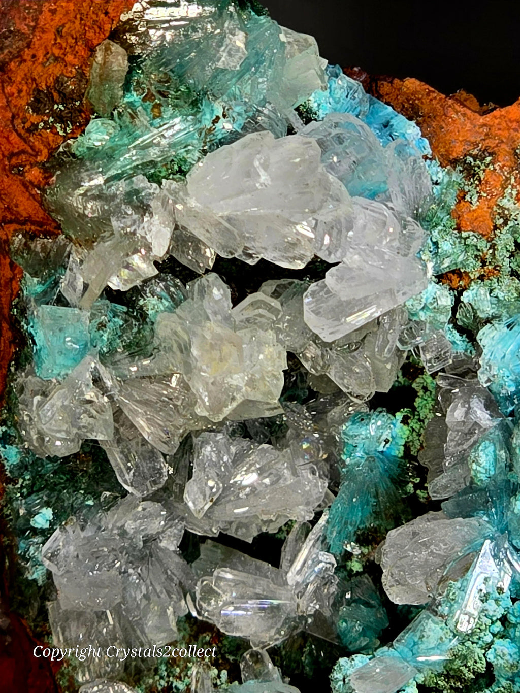 Clear quartz crystals with green and blue mineral matrix, vibrant natural specimen
