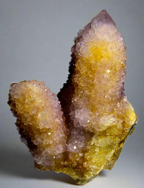 Amethyst and citrine crystal cluster from Brazil, showcasing natural purple and yellow mineral formations