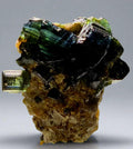 Tourmaline crystal specimen from Brazil, vibrant green to black striations on matrix, mineral collector piece