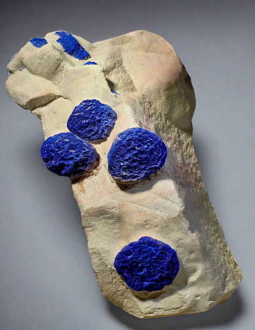 Vivid blue azurite mineral clusters on light matrix, classic specimen for collectors