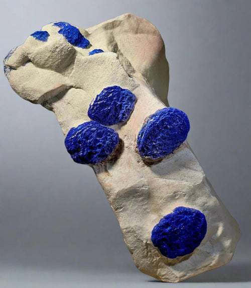 Azurite on matrix specimen, vibrant blue mineral clusters on light host rock