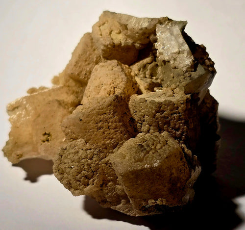 Calcite crystal specimen with earthy matrix, showcasing natural mineral formation and texture