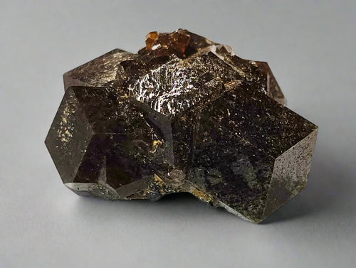 Fluorite crystal with metallic luster and orange inclusions, mineral specimen for collectors