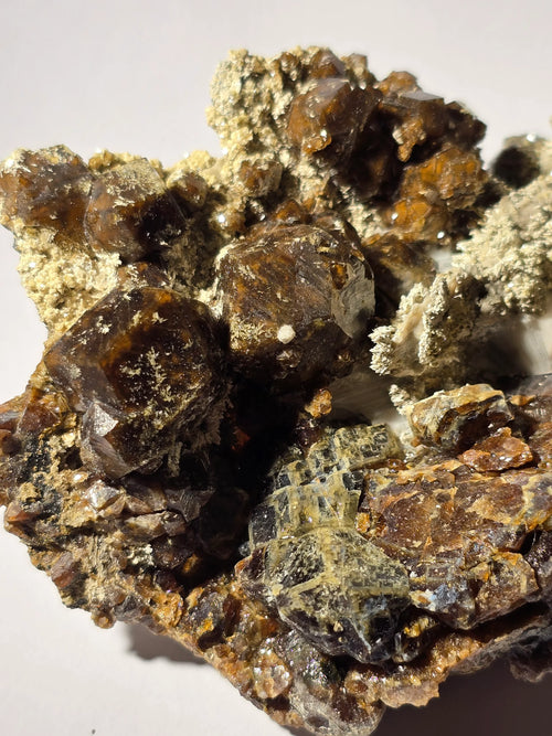 Sphalerite crystals on matrix, showcasing rich brown and golden hues with metallic luster, ideal for mineral collectors.