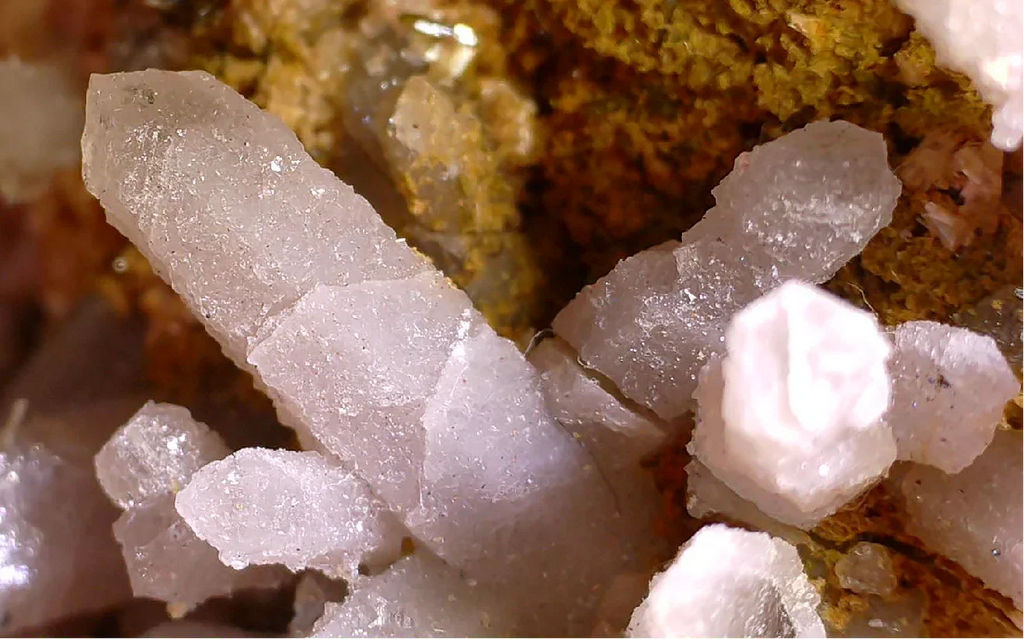 Apophyllite crystals from India, translucent white with cubic formations on earthy matrix